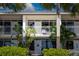 Charming two-story condo building with white trim, balconies, tropical foliage and a serene, inviting atmosphere at 611 Destiny Dr # 204, Ruskin, FL 33570