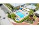 Inviting community pool with ample seating, lush landscaping, and shaded areas at 611 Destiny Dr # 204, Ruskin, FL 33570