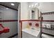 Bathroom featuring tiled shower, vanity with mirror, and coordinated accessories, creating a functional space at 6132 7Th S Ave, Gulfport, FL 33707