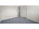 Cozy bedroom featuring soft gray carpet and a white wall with door to storage at 6132 7Th S Ave, Gulfport, FL 33707