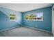Light blue bedroom featuring plush carpeting and a view to the outside at 6132 7Th S Ave, Gulfport, FL 33707