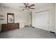 Bright bedroom featuring soft grey carpet, a ceiling fan, and a spacious closet for ample storage at 6132 7Th S Ave, Gulfport, FL 33707