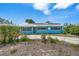 A cozy single-story home with a light blue exterior and lush front yard plants at 6132 7Th S Ave, Gulfport, FL 33707