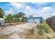 Side view of a blue home with a two-car garage, fenced yard, and driveway, perfect for parking at 6132 7Th S Ave, Gulfport, FL 33707