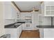 Kitchen showcases white cabinets, appliances, and countertops, perfect for culinary enthusiasts and gatherings at 6132 7Th S Ave, Gulfport, FL 33707