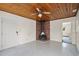 Cozy living room featuring a wood-paneled ceiling, vintage fireplace, and ample space for entertaining guests at 6132 7Th S Ave, Gulfport, FL 33707