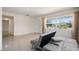 Open-concept living room with large windows, terrazzo floors, and a gray sofa at 6132 7Th S Ave, Gulfport, FL 33707