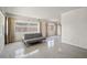 Bright living room featuring terrazzo floors, neutral walls, and a gray sofa at 6132 7Th S Ave, Gulfport, FL 33707