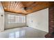Open living room featuring a wood-paneled ceiling and abundant natural light, creating a welcoming atmosphere at 6132 7Th S Ave, Gulfport, FL 33707