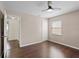 Bedroom with hardwood floors, ceiling fan, closet, and a bright window at 6183 5Th S Ave, St Petersburg, FL 33707