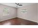 Bedroom with hardwood floors, ceiling fan, and two windows offering natural light at 6183 5Th S Ave, St Petersburg, FL 33707