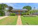 Charming single-story home with solar panels, walkway and inviting front garden at 6183 5Th S Ave, St Petersburg, FL 33707
