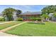 Cozy single-story home with solar panels, a well-manicured lawn, and a charming walkway at 6183 5Th S Ave, St Petersburg, FL 33707