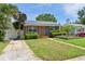 Charming home with solar panels, a well-manicured lawn and walkway at 6183 5Th S Ave, St Petersburg, FL 33707