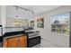 Well-lit kitchen with stainless steel appliances, tile floors, and a sunny window view at 6183 5Th S Ave, St Petersburg, FL 33707