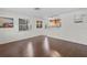 Bright living room with hardwood floors and large windows, showcasing natural light at 6183 5Th S Ave, St Petersburg, FL 33707