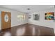 Living room features wood floors, large windows, and a front door at 6183 5Th S Ave, St Petersburg, FL 33707
