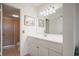 Traditional bathroom featuring a white vanity and a large framed mirror with an adjacent shower at 6269 Palma Del Mar S Blvd # 306, St Petersburg, FL 33715