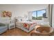 Bright bedroom featuring hardwood floors, white wicker furniture and a large window with a beautiful outdoor view at 6269 Palma Del Mar S Blvd # 306, St Petersburg, FL 33715