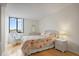 Comfortable bedroom showcases hardwood floors, a wicker chair and white walls creating a soothing retreat at 6269 Palma Del Mar S Blvd # 306, St Petersburg, FL 33715