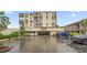 Multi-story condo building featuring private balconies, covered parking, and well maintained landscaping at 6269 Palma Del Mar S Blvd # 306, St Petersburg, FL 33715