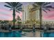 Beautiful pool area featuring palm trees and a picturesque view of the city skyline at dusk at 700 S Harbour Island Blvd # 731, Tampa, FL 33602