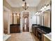 Spacious bathroom with dual vanities, tile floors, and an elegant chandelier at 704 Berrocales De Avila, Tampa, FL 33613