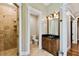 Bathroom featuring a glass enclosed shower, tiled flooring, and wooden vanity with granite countertop at 704 Berrocales De Avila, Tampa, FL 33613