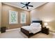 This bedroom features neutral walls, carpeted floor, ceiling fan, and two windows with blinds for natural light at 704 Berrocales De Avila, Tampa, FL 33613