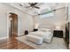 Spacious primary bedroom with tray ceilings, hardwood floors, and a doorway to a walk-in closet at 704 Berrocales De Avila, Tampa, FL 33613