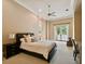 This bedroom features neutral walls, carpeted floor, fan, and sliding glass doors that lead to the outside at 704 Berrocales De Avila, Tampa, FL 33613