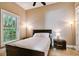 This bedroom features neutral walls, tile flooring, and a large window with blinds for natural light at 704 Berrocales De Avila, Tampa, FL 33613