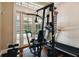 Bright workout space with exercise equipment and French doors overlooking the pool and patio at 704 Berrocales De Avila, Tampa, FL 33613