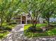 Beautiful home with a manicured front lawn, mature trees, and a grand entrance that welcomes you inside at 704 Berrocales De Avila, Tampa, FL 33613