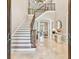 Welcoming foyer with staircase and marble flooring at 704 Berrocales De Avila, Tampa, FL 33613