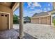 Two-car garage and brick paved driveway with side door and elegant landscaping at 704 Berrocales De Avila, Tampa, FL 33613