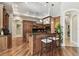 Gourmet kitchen with wooden cabinetry, granite countertops, a large island, and stainless steel appliances at 704 Berrocales De Avila, Tampa, FL 33613