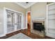 Living room with fireplace, French doors leading outside, and built in bookshelves at 704 Berrocales De Avila, Tampa, FL 33613