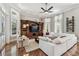 Spacious living room with built-in entertainment center, hardwood floors, and plenty of natural light at 704 Berrocales De Avila, Tampa, FL 33613