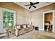 Sitting area has a decorative ceiling fan, floor to ceiling window, light-colored walls, and tile flooring at 704 Berrocales De Avila, Tampa, FL 33613