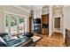 Living room with a fireplace, built-in cabinetry, and hardwood floors at 704 Berrocales De Avila, Tampa, FL 33613