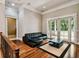 Living room with a leather sofa, hardwood floors, and sliding glass doors at 704 Berrocales De Avila, Tampa, FL 33613