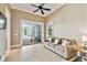 Comfortable living room with neutral furnishings and tiled floors, leading to a screened outdoor space at 704 Berrocales De Avila, Tampa, FL 33613