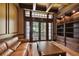Well-lit office space with built-in bookshelves, coffered ceilings, and access to a balcony at 704 Berrocales De Avila, Tampa, FL 33613