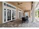 Spacious outdoor dining area on a covered patio with brick flooring and ceiling fans at 704 Berrocales De Avila, Tampa, FL 33613