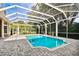 Beautiful in-ground swimming pool inside of a screened in lanai with brick flooring at 704 Berrocales De Avila, Tampa, FL 33613