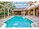 Inviting screened-in pool area with outdoor bar and ample brick-paved patio space for entertaining at 704 Berrocales De Avila, Tampa, FL 33613