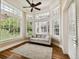 Cozy sunroom with abundant windows, tray ceiling, and an overhead fan, offering serene views at 704 Berrocales De Avila, Tampa, FL 33613
