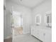 Elegant bathroom with double vanity, frameless shower and bright natural light at 718 Desert Hills Way, Sun City Center, FL 33573
