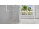 Elegant bathroom with frameless shower, bright natural light and decorative tilework at 718 Desert Hills Way, Sun City Center, FL 33573